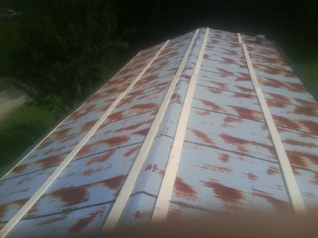Rusted metal roof panels with new wood purlins before replacement — Storm Damage Roof Repair in Daisytown by Roofing Brothers