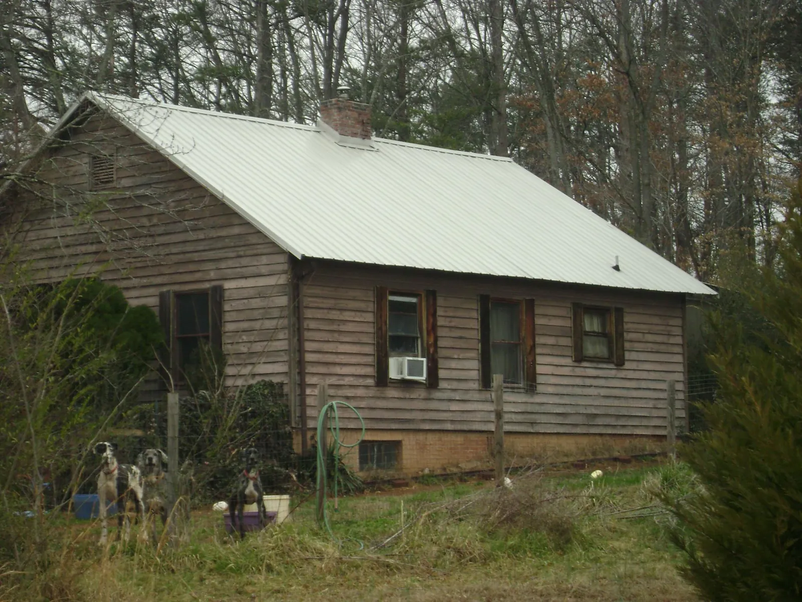 White metal roof on an old wood sided farmhouse, from a Metal Roof Installation job in Daisytown